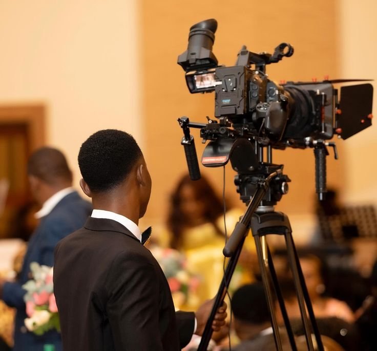 Videographer filming an indoor event